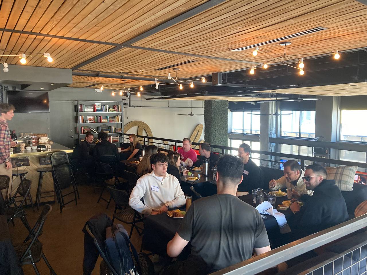 A picture of attendees eating brunch and networking.